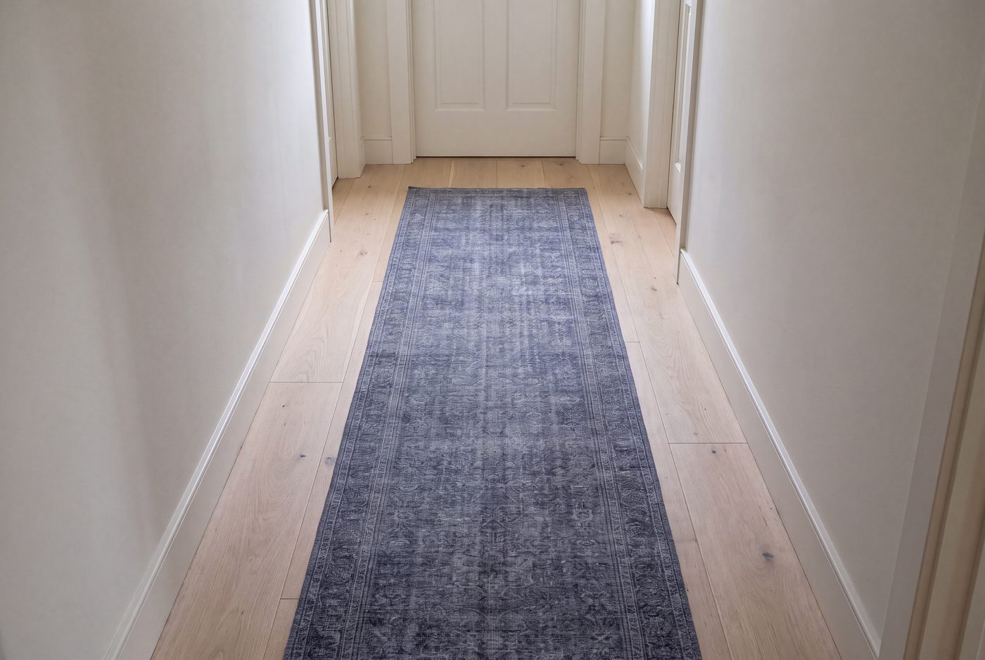 A hallway runner with an even margin of bare floor on both sides